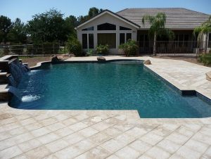 matching pool to home with water features and decks